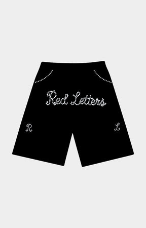 Black shorts featuring 'Red Letters' in white cursive rhinestone lettering across the front, with decorative rhinestone arches near the waistband and matching monogram details on the lower legs. Red Letters Black Pearled French Terry Shorts front view.