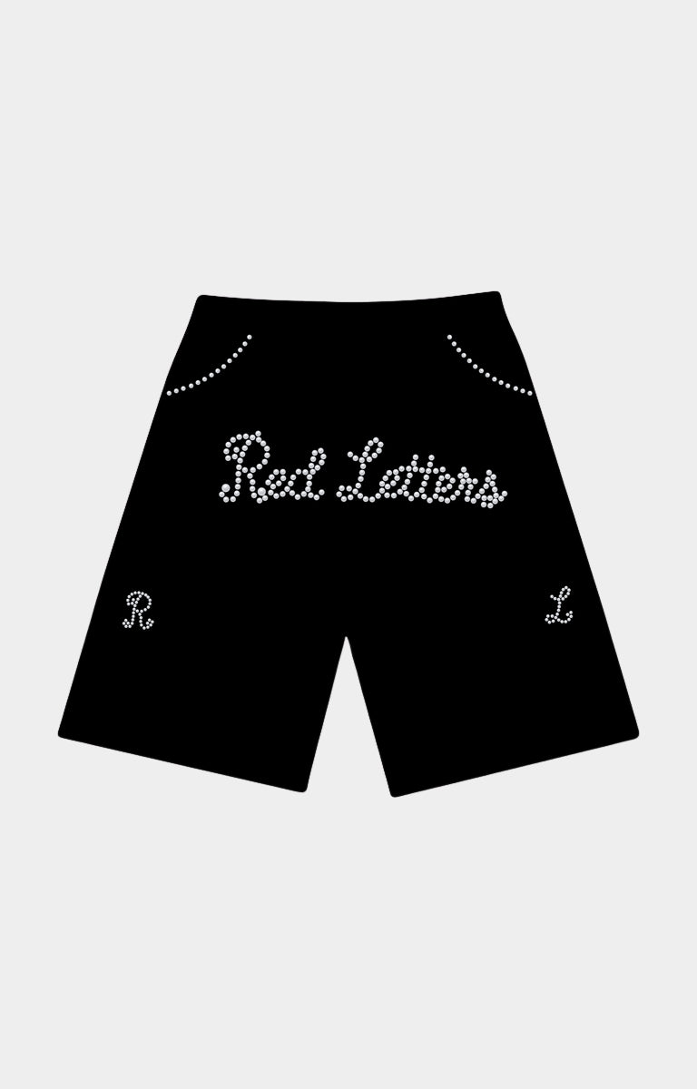 Black shorts featuring 'Red Letters' in white cursive rhinestone lettering across the front, with decorative rhinestone arches near the waistband and matching monogram details on the lower legs. Red Letters Black Pearled French Terry Shorts front view.