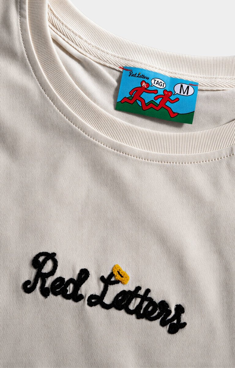 Chain stitch Red Letters embroidered logo on Off White tee.