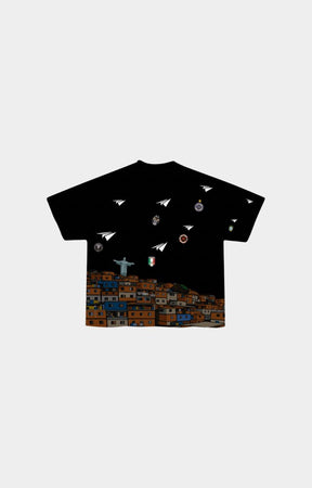 Red Letters Favelas black short-sleeve t-shirt with a graphic print of paper airplanes and small circular illustrations floating above a colorful hillside town. 