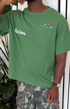 Front view of Red Letters At The Garden green streetwear tee.