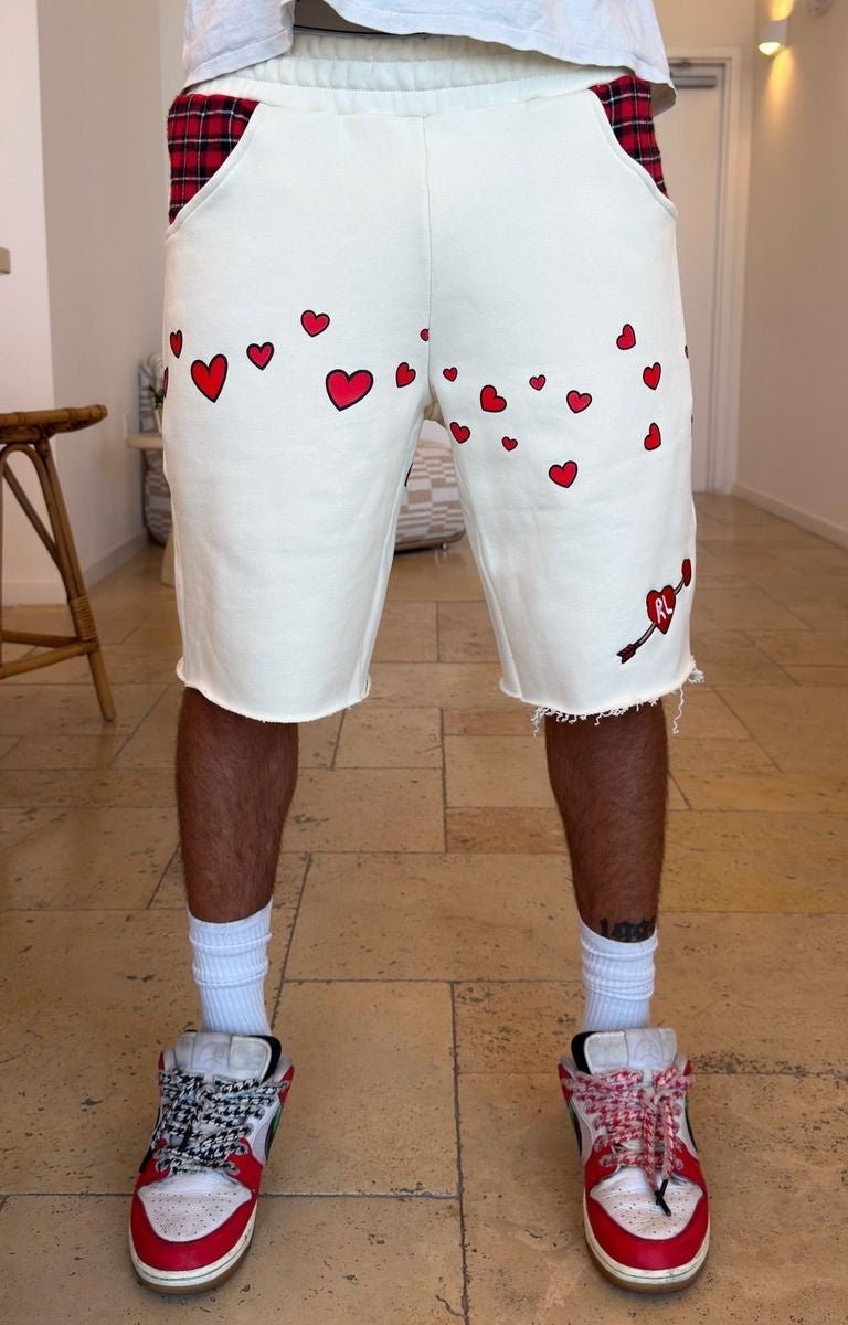 Red Letters Off white shorts with red heart prints and red plaid pocket flaps, hand frayed distressed hem. 