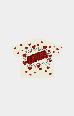 A cream-colored short-sleeve t-shirt with a red comic-style graphic reading 'LETTERS' inside a burst, surrounded by small red hearts.