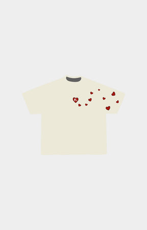 Red Letters Love letter cream-colored short-sleeve t-shirt with small red heart graphics scattered across the chest and shoulder area.