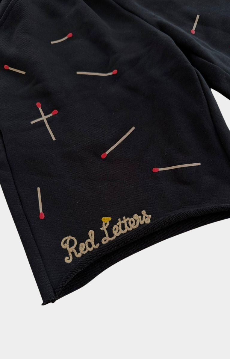Matchstick graphic detail on Red Letters Start The Fire shorts.