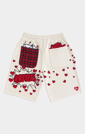 Red Letters Off-white shorts with red heart prints, a red plaid pocket graphic, and a comic-style 'LETTERS' graphic on the back.