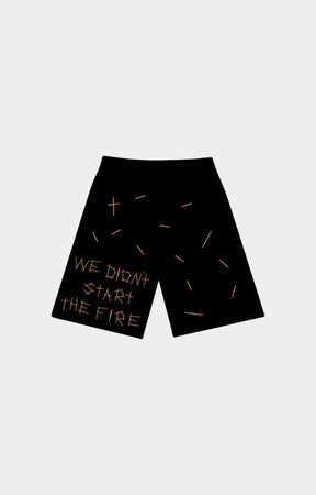 Red Letters start the fire french terry Black shorts with a graphic design featuring the text 'WE DIDN'T START THE FIRE' in white, accompanied by matchsticks design all over at back side. 