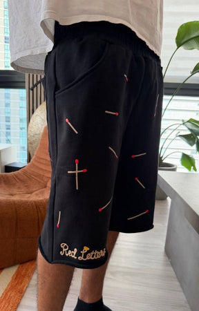 Angled view of Red Letters Start The Fire shorts.