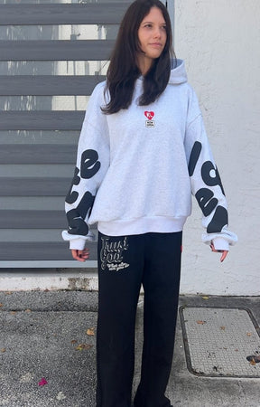 Front View of Model wearing oversized Red Letters Therapy Scattered Hoodie in streetwear fit.