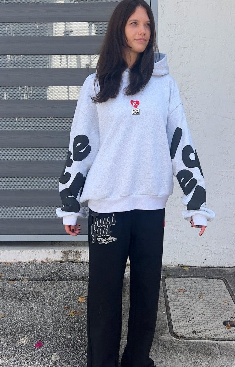 Front View of Model wearing oversized Red Letters Therapy Scattered Hoodie in streetwear fit.