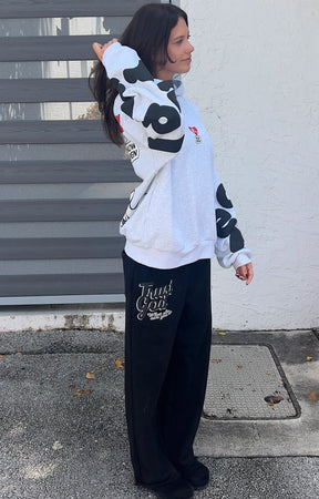 Side View of Model wearing oversized Red Letters Therapy Scattered Hoodie in streetwear fit.