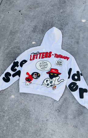 Flat lay of Red Letters Therapy Scattered Hoodie showing front and back design