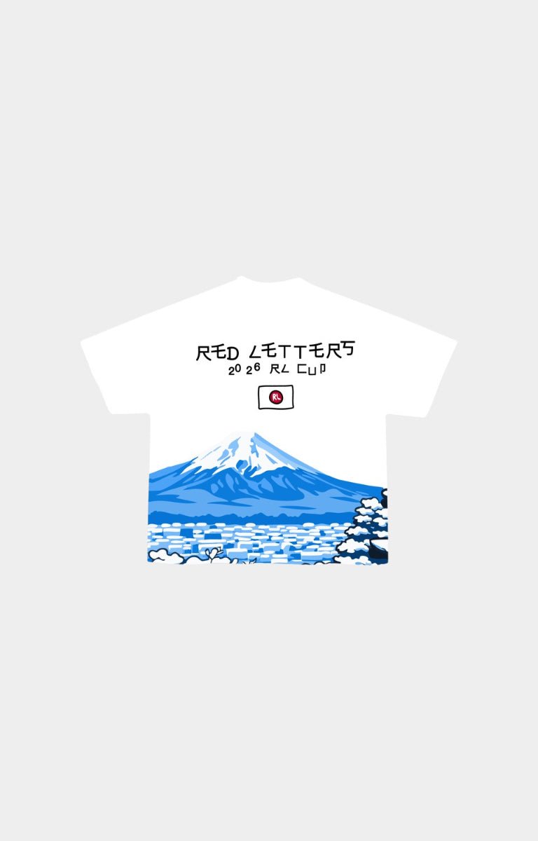 Red Letters Japan Fuji short-sleeve t-shirt with a graphic print of Mount Fuji, snow-covered trees, and blue water, featuring the text 'RED LETTERS 2025 RL CLUB' and a small red circle logo on the chest. 