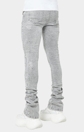 Back view of GUAPI Smoke Grey distressed skinny jeans with cross motifs.