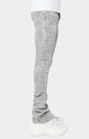 Smoke Grey stacked skinny jeans with embroidered GUAPI waistband logo.