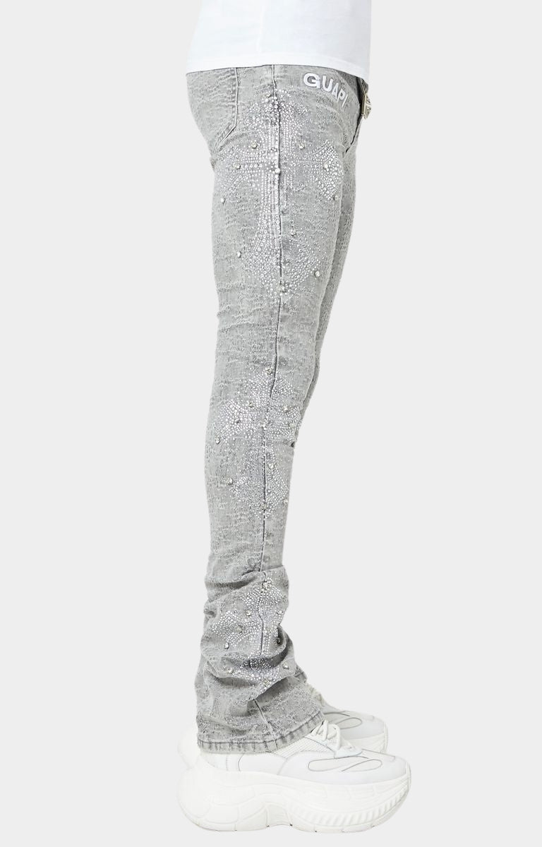 Smoke Grey stacked skinny jeans with embroidered GUAPI waistband logo.