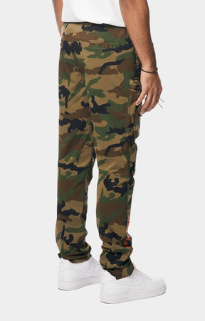Smoke Rise camouflage cargo jogger pants with side cargo pockets, paired with a white t-shirt and white sneakers, shown from the waist down.