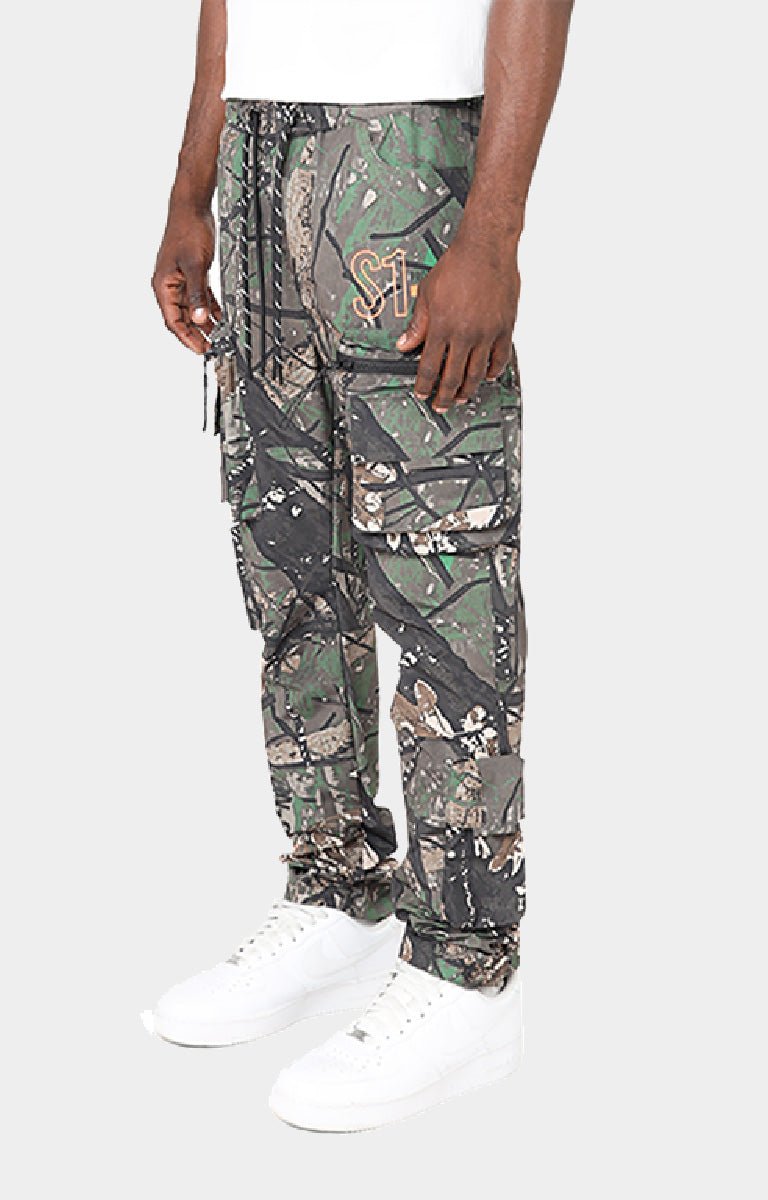 Smoke Rise camouflage cargo jogger pants with a adjustable drawstring waist and white sneakers. 