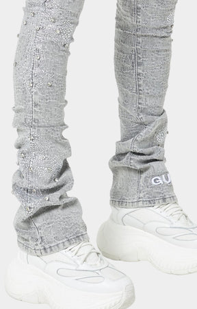 Urban fashion grey stacked jeans with white embroidered GUAPI logo.