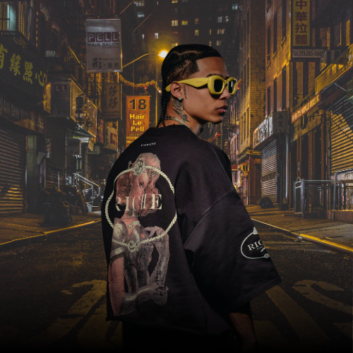 Man wearing Vie Riche graphic backprint oversized tee in night city alley