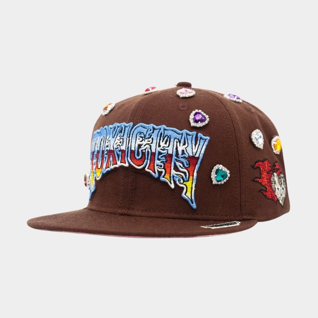 Multicolor gem embellishments on crown of Brown Toxicity 333 Snapback