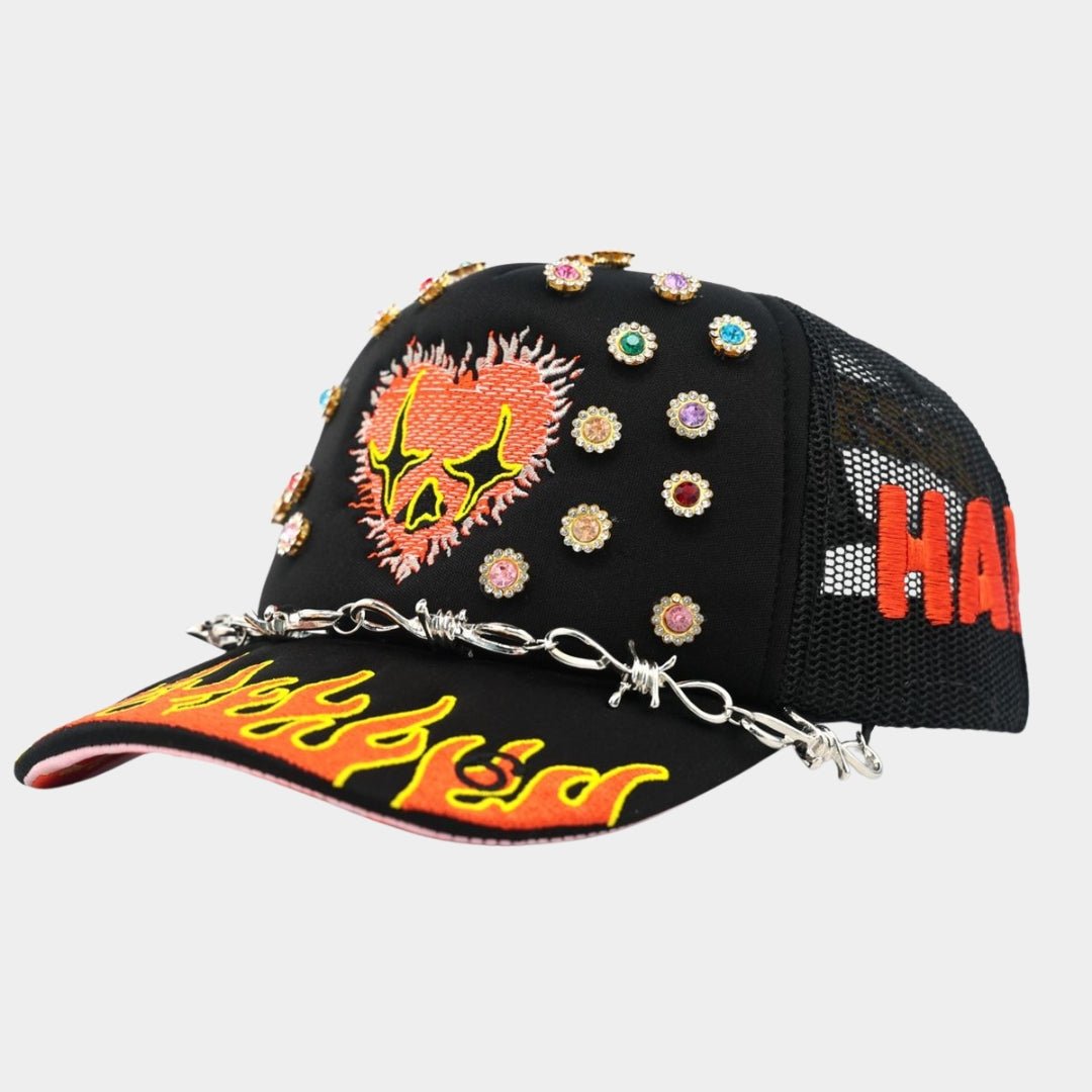 Close-up of flaming heart embroidery on Toxicity Love Hard Trucker Hat