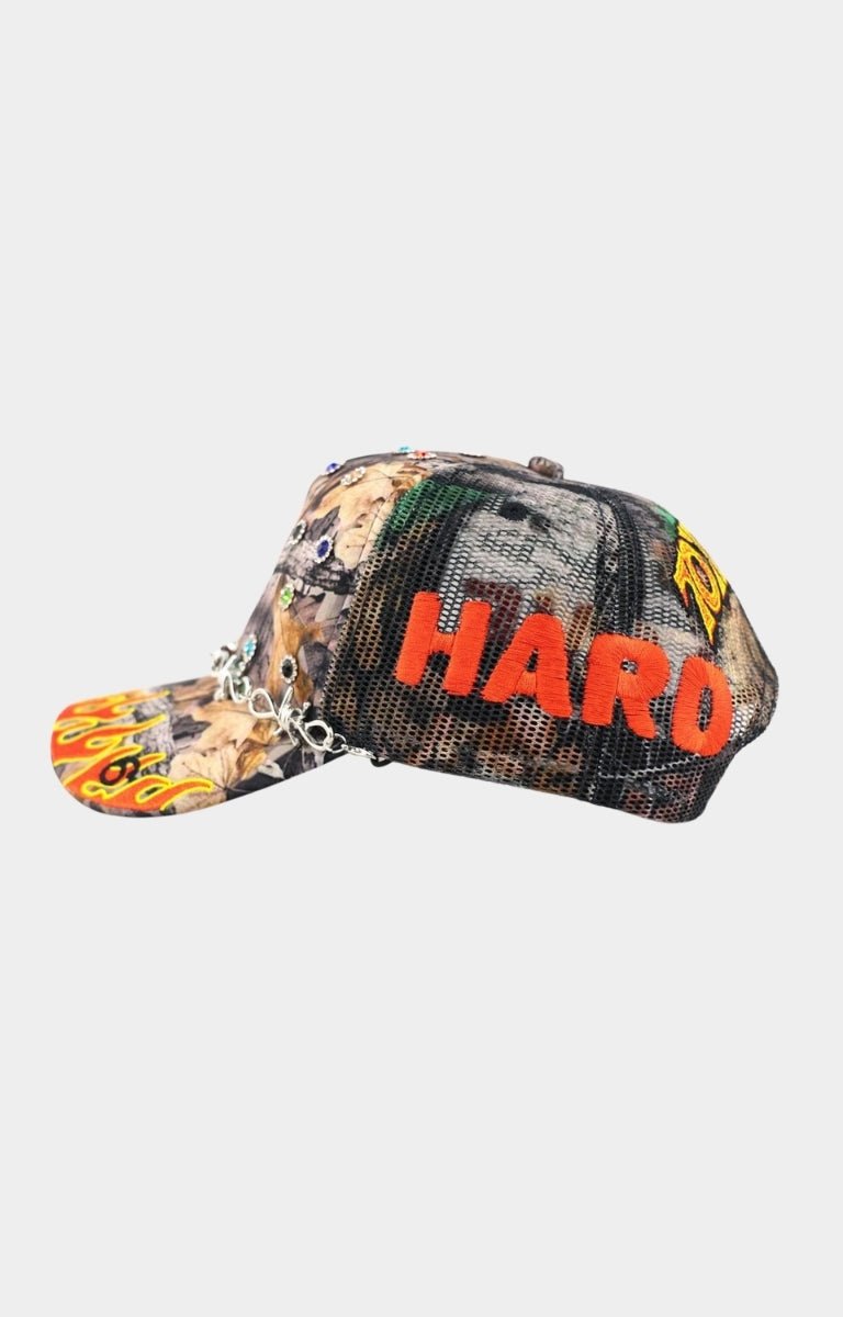 Angled view of LOVE HARD structured camo cap.