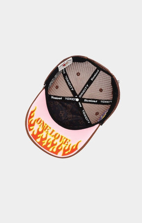 Curved brim detail of cream and black cap.