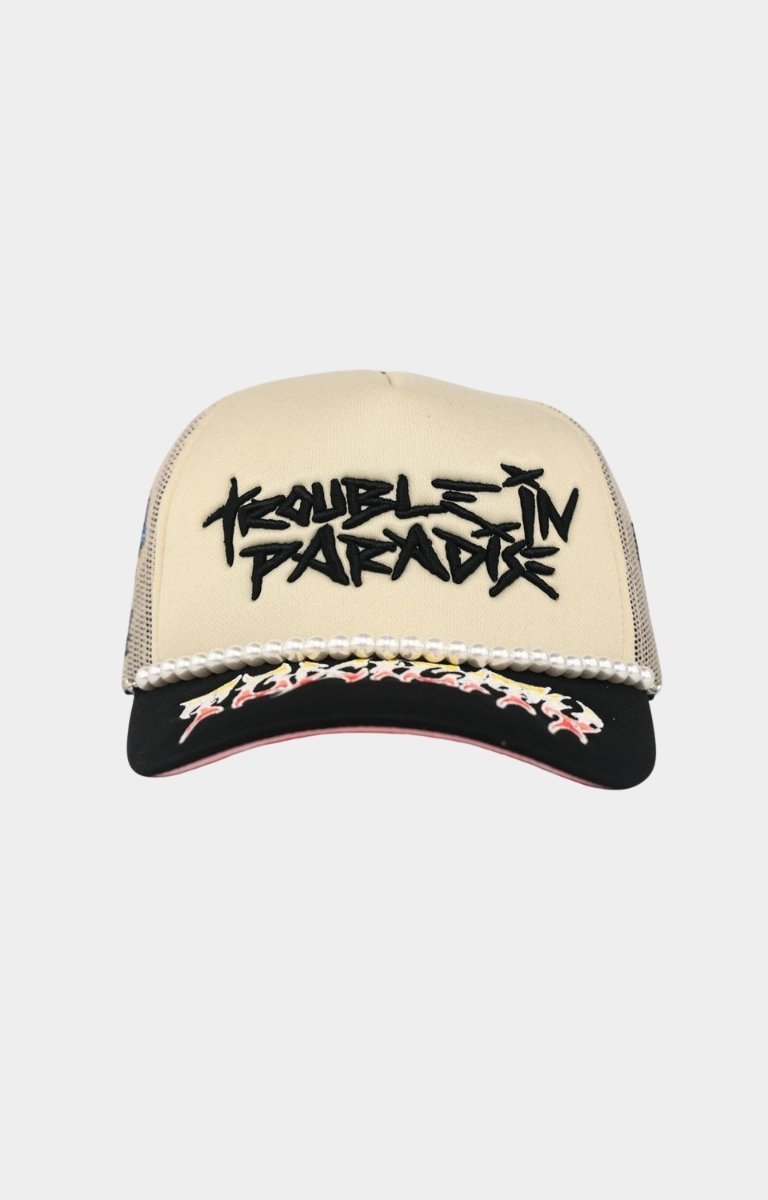 Toxicity Trouble In Paradise trucker hat in cream and black front view.