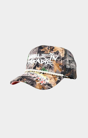 Angled view of rhinestone Trouble In Paradise camo hat.
