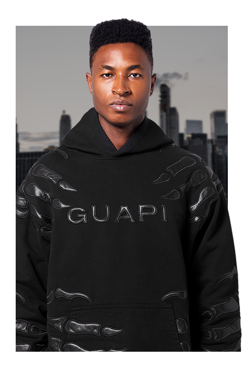 Model in black Guapi hoodie with embossed logo – men’s streetwear