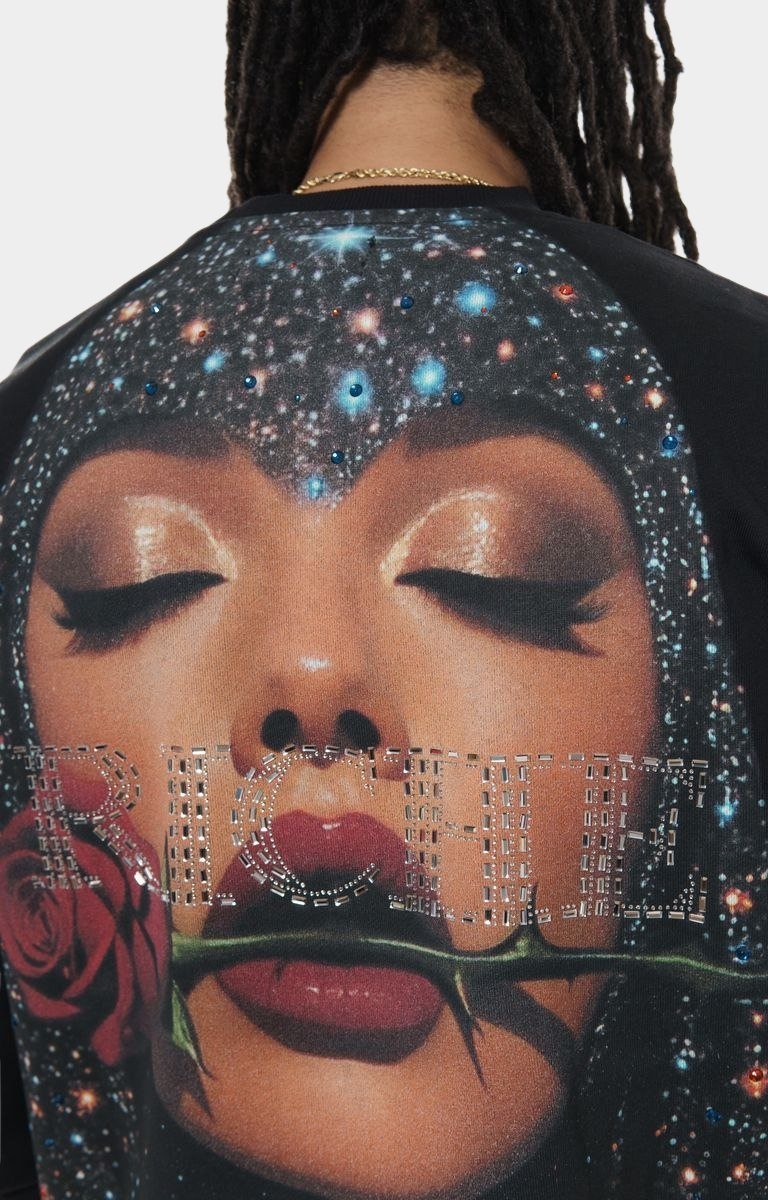 Close-up of crystal and print detailing on Vie+Riche sweatshirt.