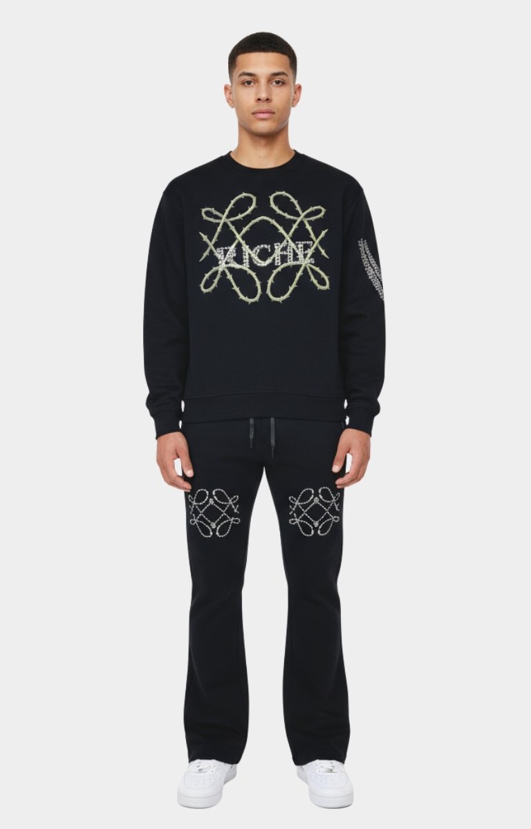 Model wearing Vie+Riche Black Live Rose sweatshirt front view with crystal details.