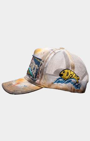 Waves x Sauce BEACH BUM STITCHED TRUCKER featuring distressed embroidered patches, hand-painted details, stitched artwork, mesh trucker construction and a vintage-inspired finish.